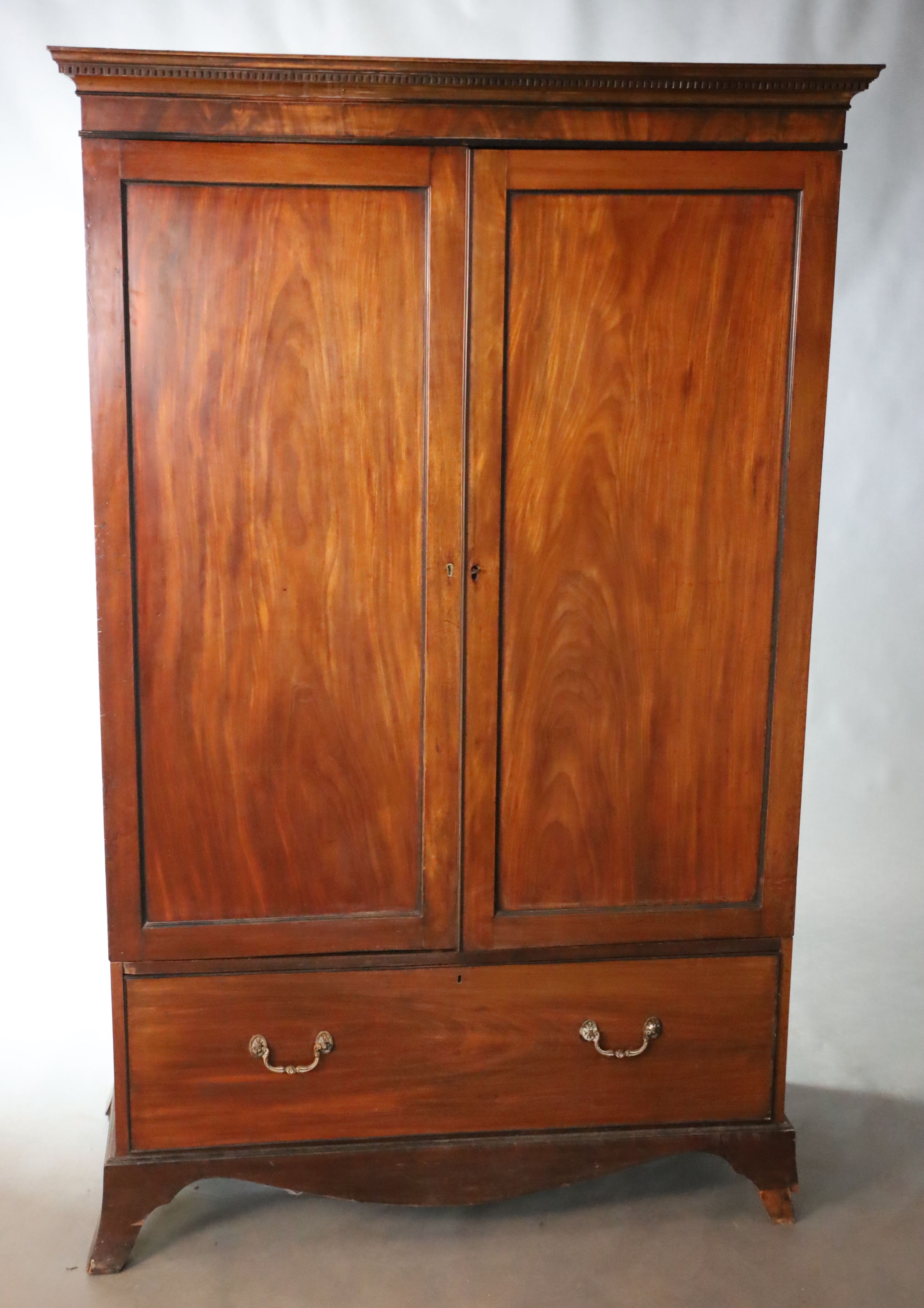 An early 19th century mahogany press cupboard, W.119.5cm D.54.5cm H.188cm